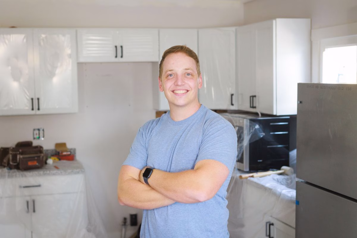 Patrick Fitzgerald smiling with arms crossed in a Cincinnati kitchen being renovated