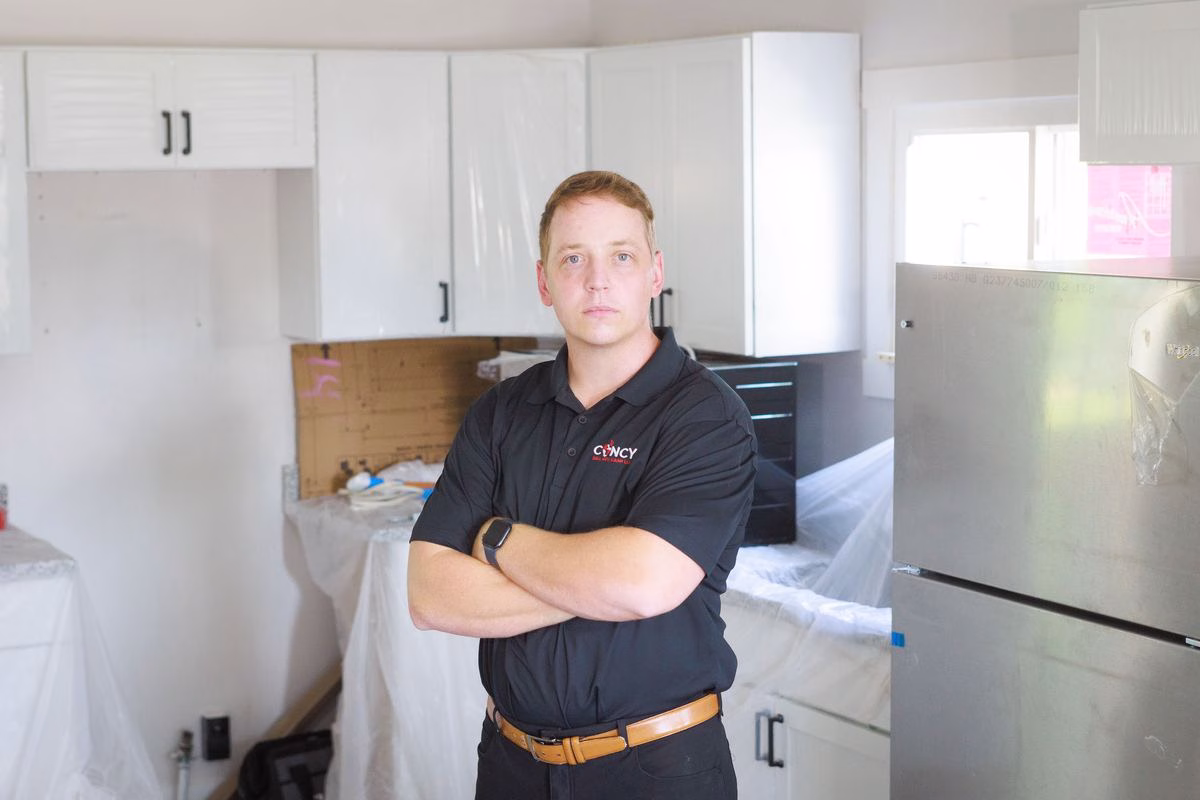 Patrick Fitzgerald, Cincinnati cash home buyer, standing with arms crossed in a house under renovation
